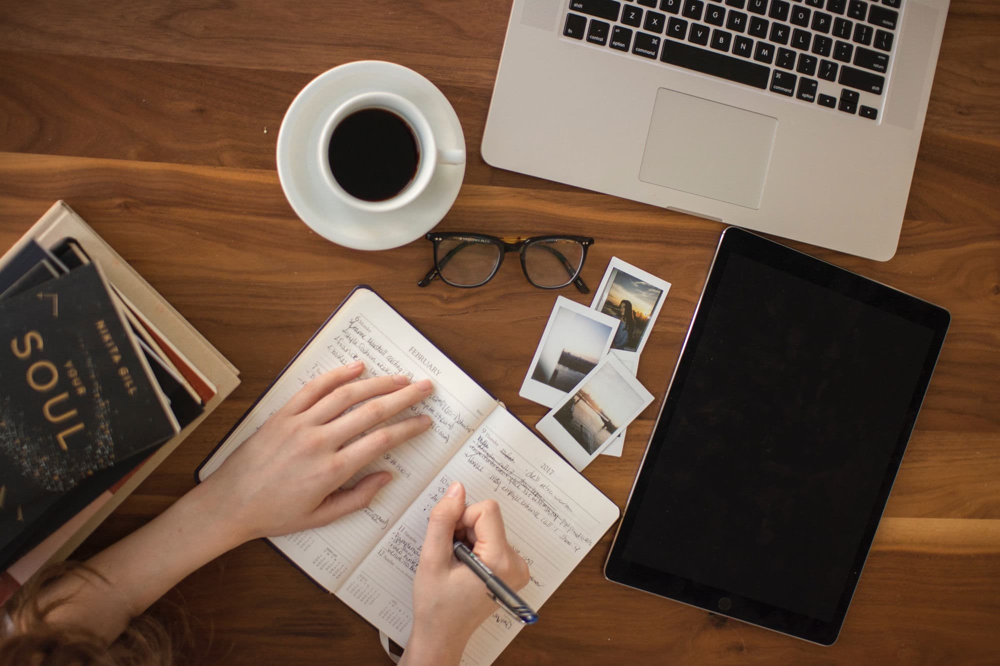 Desk flat lay with a coffee, journal, laptop, and tablet, color-matched to the page palette