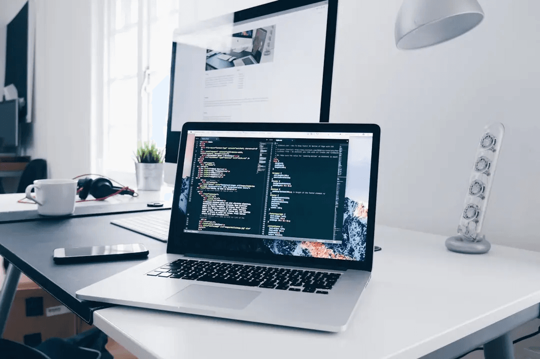 Laptop with code on a developer's desk